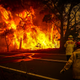 Fire and Rescue personal watch a bushfire as it burns near homes on the outskirts of the town of Bilpin on December 19, 2019 in Sydney, Australia.